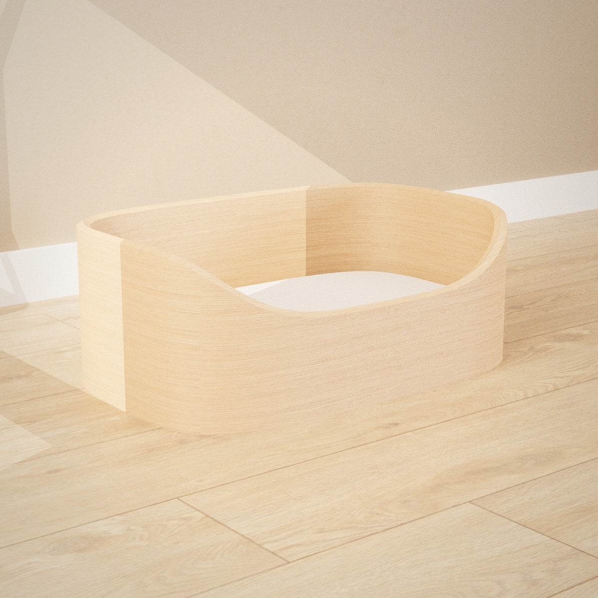 Maru Pet Bed: curved bentwood pet bed with a soft grey cushion, seen from the left