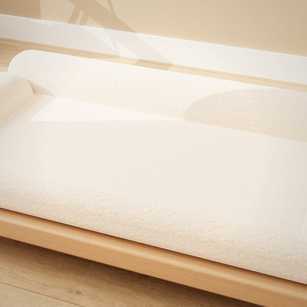 Shiro Pet Sofa: low oak pet sofa with a cream bouclé cushion and bolster sides, close-up of the cushion and wood finish