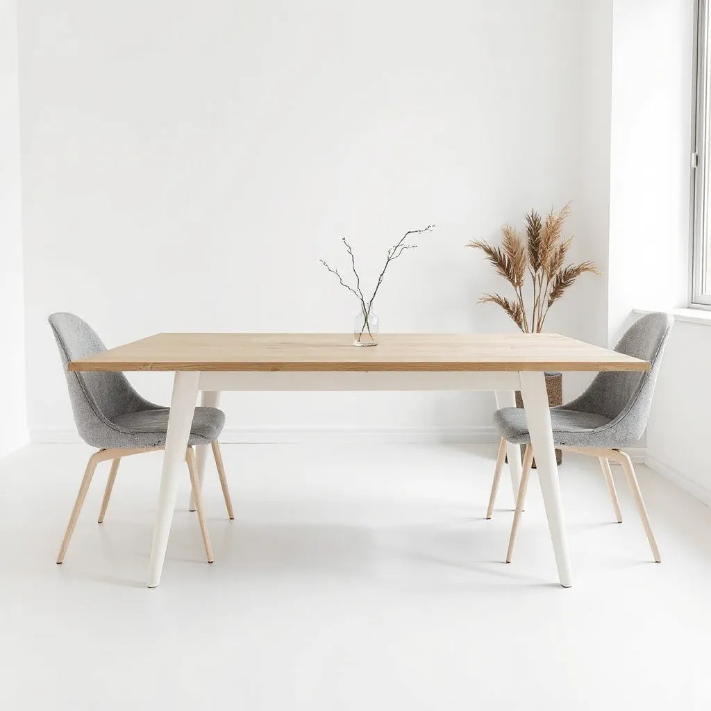 Minimalist dining table in a bright, uncluttered room with neutral decor and simple chairs