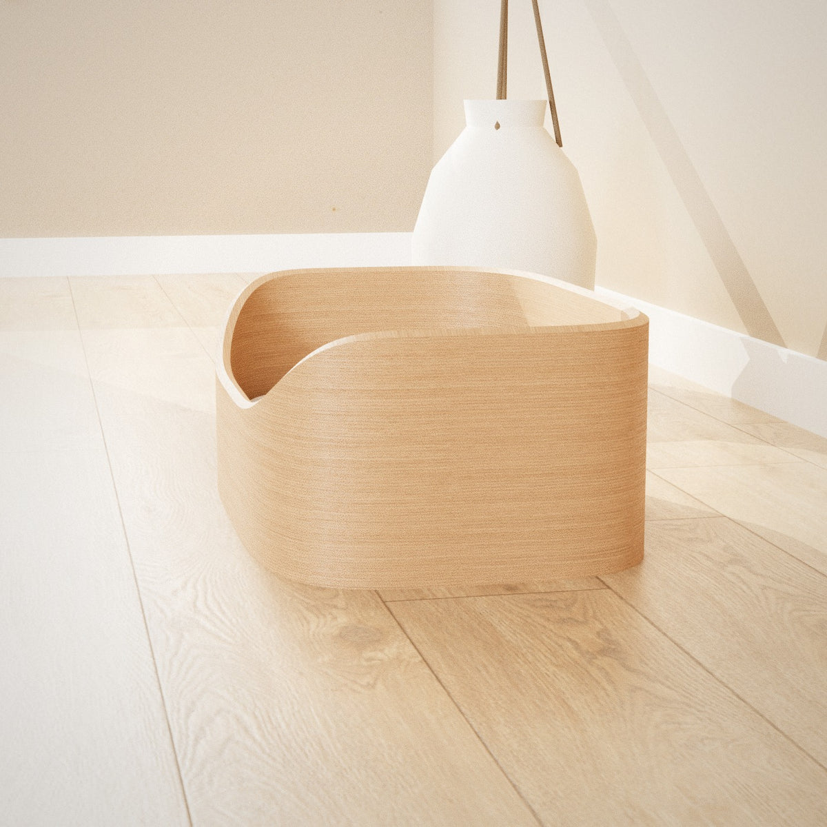 Maru Pet Bed: curved bentwood pet bed with a soft grey cushion, seen from the side