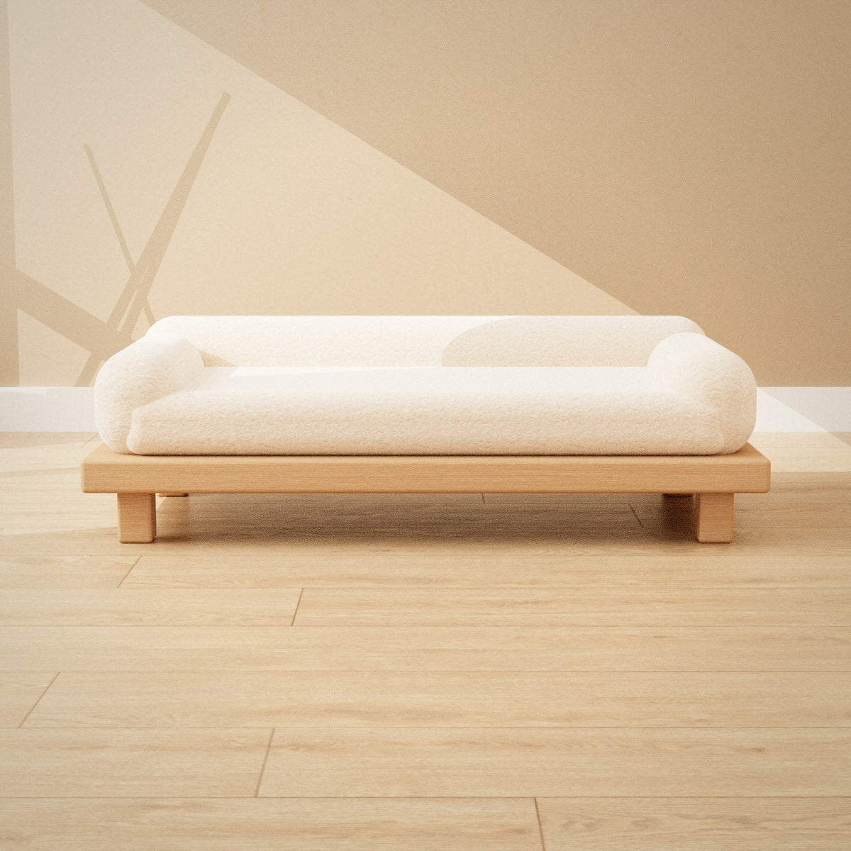 Shiro Pet Sofa: low oak pet sofa with a cream bouclé cushion and bolster sides, seen from the front